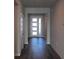Inviting entryway featuring wood-look floors and a modern front door with sidelights at 17041 James Trl, Parrish, FL 34219