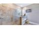 Tiled bathroom featuring a glass enclosed shower and tub, along with neutral decor at 17917 Tavernside Trl, Lakewood Ranch, FL 34211