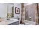 Cozy bathroom with shower-tub combo, modern vanity, stylish decorative accents, and a neutral color palette at 17917 Tavernside Trl, Lakewood Ranch, FL 34211