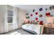 Modern bedroom with white brick accent wall, quirky record decor, neutral color palette, and ample natural light at 17917 Tavernside Trl, Lakewood Ranch, FL 34211