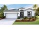 Charming single-Gathering home featuring a two-car garage, well-manicured lawn, and tropical landscaping at 17917 Tavernside Trl, Lakewood Ranch, FL 34211