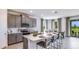 Modern kitchen featuring gray cabinets, quartz countertops, stainless steel appliances, and an island with seating at 17917 Tavernside Trl, Lakewood Ranch, FL 34211