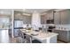 Modern kitchen featuring gray cabinets, stainless steel appliances, a central island, and an open, airy design at 17917 Tavernside Trl, Lakewood Ranch, FL 34211
