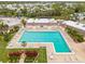 Aerial view of the community pool with ample lounge seating and manicured landscaping at 182 Crown Point Dr, Nokomis, FL 34275