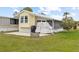 Charming backyard with a concrete patio and covered grill perfect for outdoor enjoyment at 182 Crown Point Dr, Nokomis, FL 34275