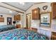 Bedroom with large mirror, desk, bed, and a large window for natural light and views at 182 Crown Point Dr, Nokomis, FL 34275
