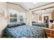 Bright bedroom features a large window with a view, ample closet space, and a comfortable bed at 182 Crown Point Dr, Nokomis, FL 34275