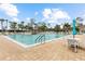 Large community pool with patio seating and umbrellas for relaxing poolside at 182 Crown Point Dr, Nokomis, FL 34275