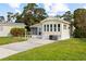 Attractive yellow house with a lovely screen porch, neat lawn, and paved driveway in a quiet setting at 182 Crown Point Dr, Nokomis, FL 34275