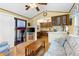 Comfortable living room seamlessly connecting to the kitchen, featuring cozy seating and wood laminate floors at 182 Crown Point Dr, Nokomis, FL 34275
