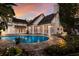 Stunning backyard featuring a pristine pool, stone patio, and lush landscaping, creating a perfect outdoor oasis at 1829 Bougainvillea St, Sarasota, FL 34239