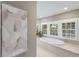 Bright bathroom with a soaking tub, natural light, and neutral tones offers a spa-like experience at 1829 Bougainvillea St, Sarasota, FL 34239