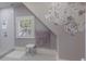 Stylish bathroom featuring floral wallpaper, a shower, and natural light through shuttered windows at 1829 Bougainvillea St, Sarasota, FL 34239