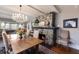 This dining room features a stone fireplace, hardwood floors, and a charming chandelier at 1829 Bougainvillea St, Sarasota, FL 34239