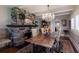 This dining room features a stone fireplace, hardwood floors, and a charming chandelier at 1829 Bougainvillea St, Sarasota, FL 34239