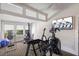 Bright exercise room features a variety of equipment and a television for an engaging workout experience at 1829 Bougainvillea St, Sarasota, FL 34239