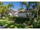 Beautiful Tudor-style home with lush landscaping and well-maintained lawn at 1829 Bougainvillea St, Sarasota, FL 34239
