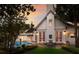 Elegant home exterior with a manicured lawn, stone patio, and a charming bench by the french doors at 1829 Bougainvillea St, Sarasota, FL 34239