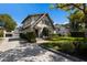 Stately Tudor-style home with manicured landscaping, paver driveway, and charming entry at 1829 Bougainvillea St, Sarasota, FL 34239