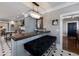 Chic kitchen with breakfast bar, chandelier, and black and white tiled floor at 1829 Bougainvillea St, Sarasota, FL 34239