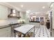 Bright kitchen showcases custom cabinets, marble island, stainless steel appliances, and a stylish chandelier at 1829 Bougainvillea St, Sarasota, FL 34239