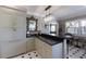 Elegant kitchen with custom cabinets, marble countertops, crystal chandelier, and black and white tiled floor at 1829 Bougainvillea St, Sarasota, FL 34239