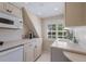 Charming kitchenette features light cabinetry, stainless appliances, and a bright window at 1829 Bougainvillea St, Sarasota, FL 34239