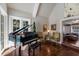 Living room featuring a piano, vaulted ceiling, and access to a pool at 1829 Bougainvillea St, Sarasota, FL 34239