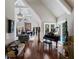 Elegant living room with a grand piano, hardwood floors, high ceilings, and access to a pool at 1829 Bougainvillea St, Sarasota, FL 34239