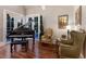 Living room with a piano, and access to a pool area at 1829 Bougainvillea St, Sarasota, FL 34239