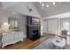 Bright living room with hardwood floors, fireplace, mounted TV, and elegant chandelier at 1829 Bougainvillea St, Sarasota, FL 34239