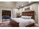 This main bedroom features a carved-wood bed and opens up to a patio with a pool at 1829 Bougainvillea St, Sarasota, FL 34239