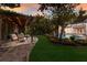 Outdoor living area features a covered pergola, lounge seating, and a lushly landscaped backyard at 1829 Bougainvillea St, Sarasota, FL 34239