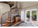 The home has a beautiful spiral staircase with hardwood treads, balcony access, and a wet bar at 1829 Bougainvillea St, Sarasota, FL 34239
