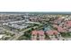 High angle view of townhouse with red tile roof, surrounded by trees and water features in a community setting at 197 Tropicana Dr # 1511, Punta Gorda, FL 33950