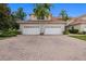Spacious red brick driveway leading to a home with a two-car garage and lush landscaping at 197 Tropicana Dr # 1511, Punta Gorda, FL 33950