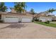 Beautifully landscaped condo building with multiple garage doors, a brick driveway, and well manicured lawn at 197 Tropicana Dr # 1511, Punta Gorda, FL 33950