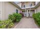 Inviting front entrance with a brick walkway, manicured landscaping, and a glimpse of the home's elegant facade at 197 Tropicana Dr # 1511, Punta Gorda, FL 33950