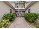 Welcoming front entrance featuring a brick pathway, tropical plants and double doors under an awning at 197 Tropicana Dr # 1511, Punta Gorda, FL 33950