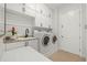 Well-equipped laundry room with front-load washer/dryer, granite countertop, and ample cabinet space for storage at 197 Tropicana Dr # 1511, Punta Gorda, FL 33950