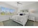 Bright bedroom featuring a ceiling fan, a plush bed and shuttered windows with a scenic view at 197 Tropicana Dr # 1511, Punta Gorda, FL 33950
