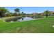 Scenic view of a tranquil pond surrounded by lush greenery and palm trees, reflecting the clear blue sky at 197 Tropicana Dr # 1511, Punta Gorda, FL 33950