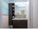 Well-lit bathroom features sleek vanity, mirrored medicine cabinet, and tiled shower at 2238 Rose St, Sarasota, FL 34239