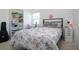 Bright bedroom with terrazzo floors, bookshelf, guitar, and large window at 2238 Rose St, Sarasota, FL 34239