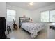 Bright bedroom with terrazzo flooring, guitar, floral bedding, and good natural light at 2238 Rose St, Sarasota, FL 34239