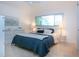 Bright bedroom with neutral walls, large window and comfortable bedding at 2238 Rose St, Sarasota, FL 34239