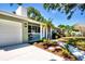 Front entrance showcasing the home's exterior with an attached garage and lush landscaping at 2238 Rose St, Sarasota, FL 34239