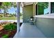 Covered front porch with seating area, lush greenery, and a well-maintained exterior at 2238 Rose St, Sarasota, FL 34239
