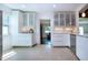 Bright kitchen features white cabinets, stainless steel appliances, and modern countertops at 2238 Rose St, Sarasota, FL 34239