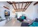 Bright living room with beamed ceilings, modern furniture, and terrazzo floors at 2238 Rose St, Sarasota, FL 34239